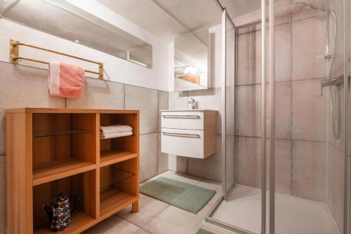 a bathroom with a shower and a glass shower stall at Roses Landhaus in Vorderhornbach