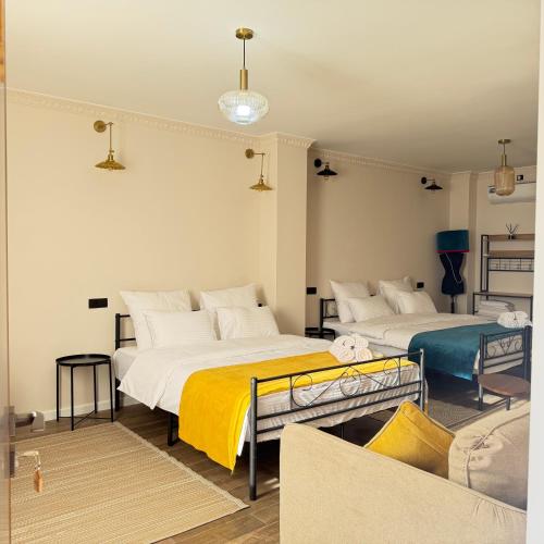 a bedroom with two beds and a couch at AMare guesthouse in Kapan