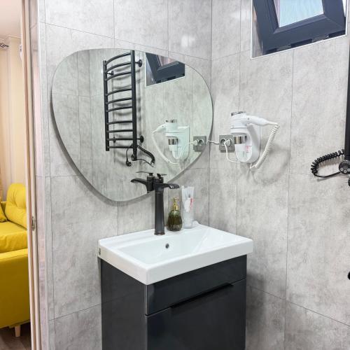 a bathroom with a sink and a mirror at AMare guesthouse in Kapan