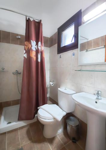 a bathroom with a toilet and a sink at THEA Panorama Studios in Vourvourou