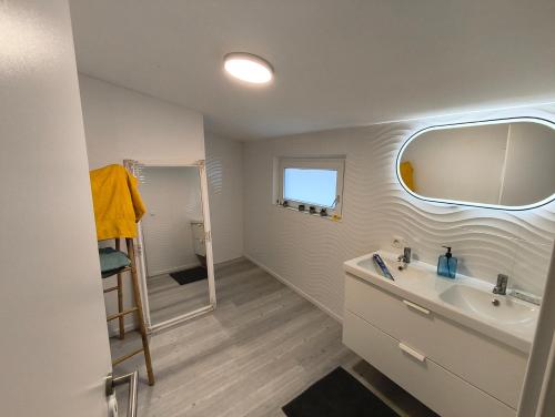 a bathroom with a sink and a mirror at The Eau Rouge 600m from the entrance of the circuit in Stavelot