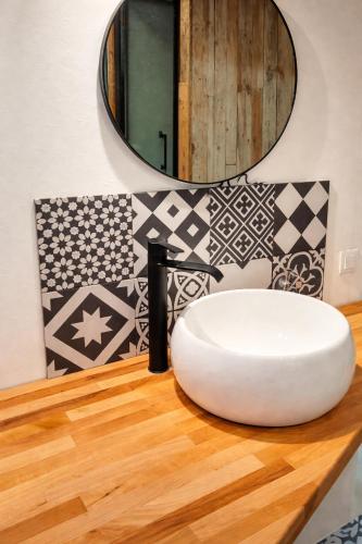 a bathroom with a white sink and a mirror at SURF HOSTEL BIARRITZ in Biarritz