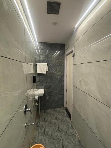 a bathroom with a sink and a toilet in a room at Hotel RK in Ujjain