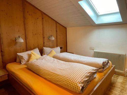 a bedroom with two beds with pillows and a window at Pechhof in Innsbruck