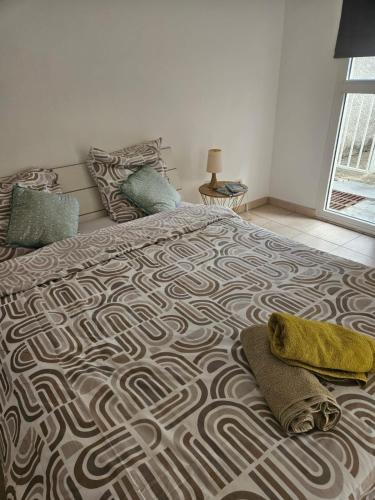 a bedroom with a large bed with a rug on it at Le paille en queue in Saint-Pierre