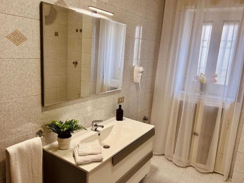 a bathroom with a sink and a mirror and a shower at B&B Torrebianca in Aversa