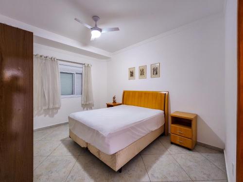 a white bedroom with a bed and a window at Casaazulvaleparaiba in Jacareí