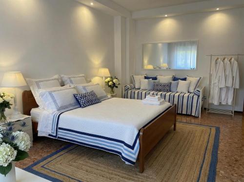 a bedroom with two beds with white and blue pillows at Lunigiana e Mare in Aulla