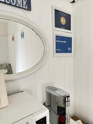 a white room with a mirror and a machine at Villa Bruna B&B in Sanremo