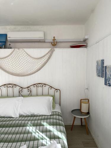 a bedroom with a bed with a green and white blanket at Villa Bruna B&B in Sanremo