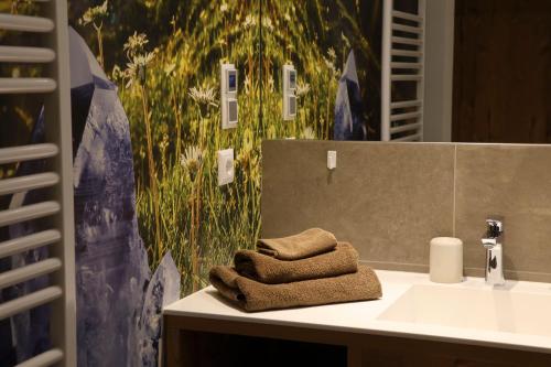 a bathroom with a sink with towels on it at Chalet Tschallener in Ried im Oberinntal