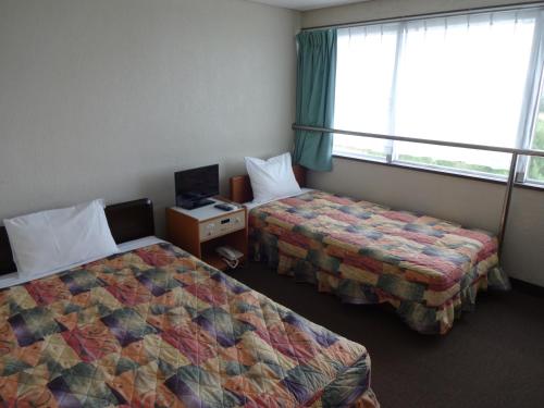 Ένα ή περισσότερα κρεβάτια σε δωμάτιο στο Hotel South Island