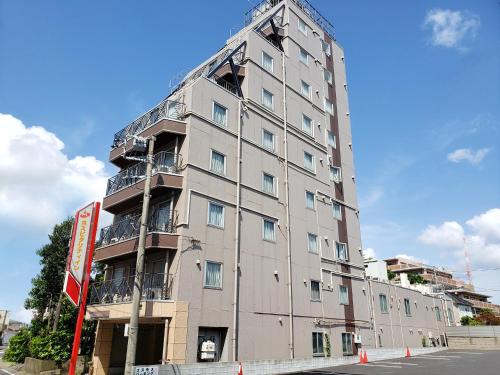a tall gray building with balconies on the side of it at Hosplitality In Yawatajuku in Ichihara