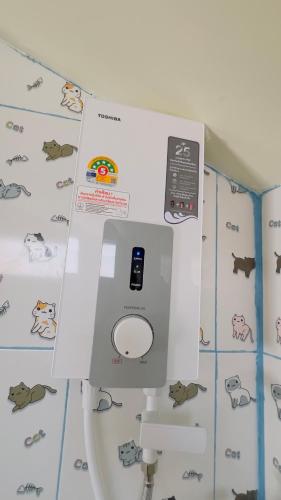 a machine on top of a toilet in a room at Thung Setthi Homestay&Cafe5 in Chiang Dao