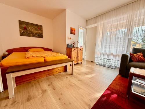 a bedroom with a bed with a bench in it at Seenest 'Paradies' mit Parkplatz in Konstanz