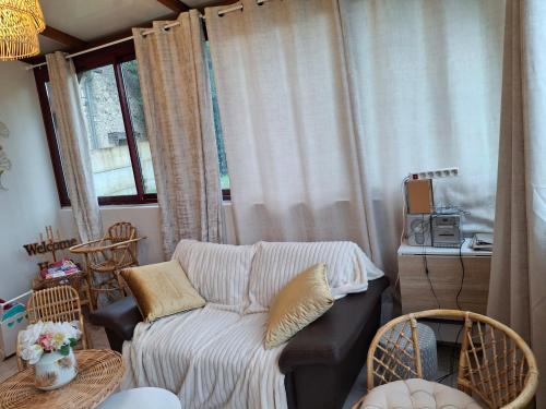 a living room with a couch and a window at maison village 3 chambres 30 minutes du zoo de beauval in Saint-Cyran-du-Jambot