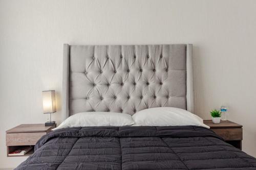 a bedroom with a large bed with a large headboard at Casa Brianzzas in Miranda