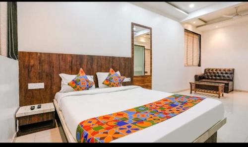 a bedroom with a large bed in a room at Hotel Krishna Inn in Bhiwandi