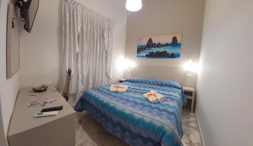 a small bedroom with a bed and a table at Debora Holiday House in Misterbianco
