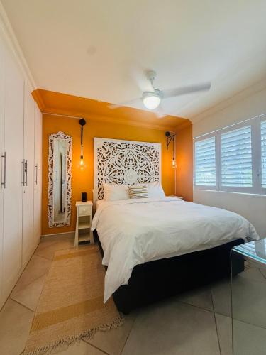 a bedroom with a large bed with orange walls at Deja Blue in Westbrook