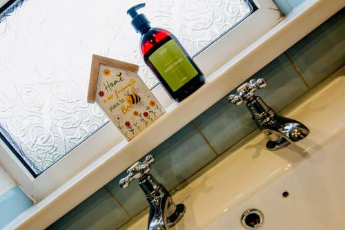 a bottle of wine sitting on top of a sink at Chapel Bricks in Withernwick