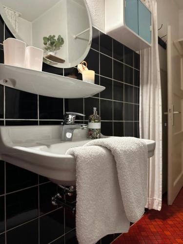 a bathroom with a sink with towels on it at Zimmer, Apartment A3 in Offenberg
