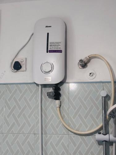 a water heater on a wall in a bathroom at Luna Fortuna Villa in Tangalle