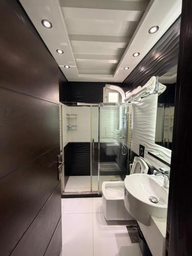 a bathroom with a sink and a toilet at ZORA Suites hotel in Jounieh