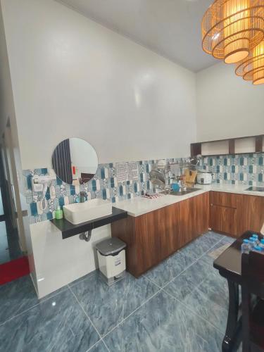 a bathroom with a sink and a mirror at Cherry House villa in Hà Tiên