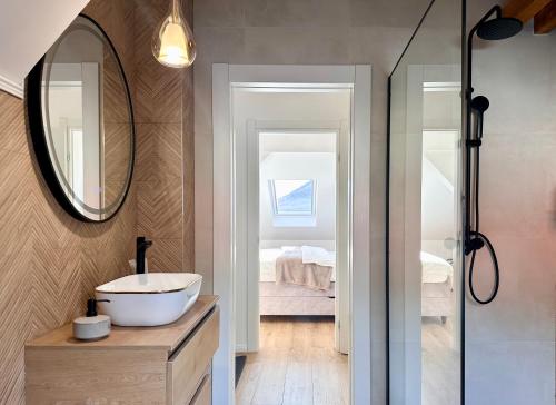 a bathroom with a sink and a mirror at Apartman Romić in Vrlika