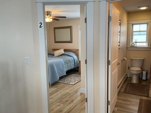 a small bedroom with a bed and a toilet at Roberts Lake House Room# 2 in Colchester