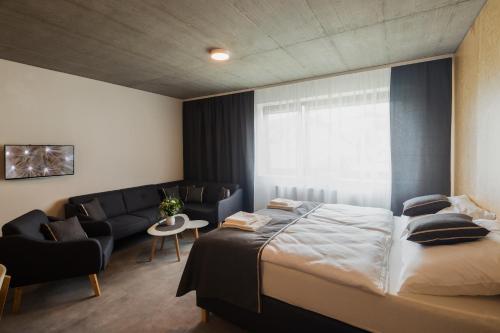 a hotel room with a bed and a couch at Residence Trafick in Prague