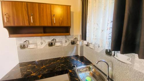 a bathroom with a sink and wooden cabinets at Coco Wave Midigama in Midigama East