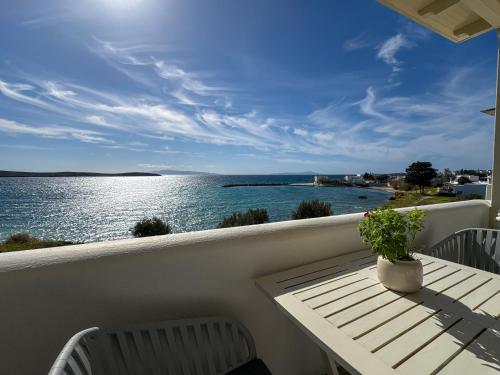 a balcony with a table and a view of the water at Kleanthi Apartments in Drios