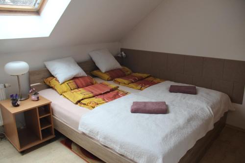 a bedroom with two beds with towels on them at Apartment Lilianna in Karlovy Vary