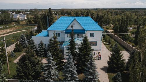 an overhead view of a house with a blue roof at Усадьба in Kostanay