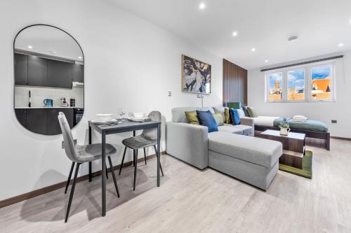 a living room with a couch and a table at Green Studio Suite - Central London - Near Station in London