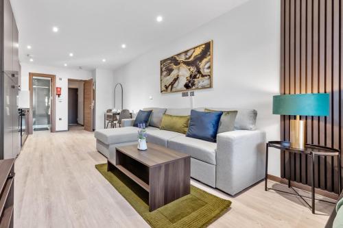 a living room with a couch and a table at Green Studio Suite - Central London - Near Station in London