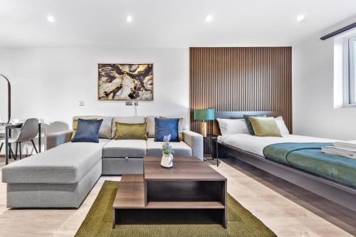 a living room with a couch and a table at Green Studio Suite - Central London - Near Station in London