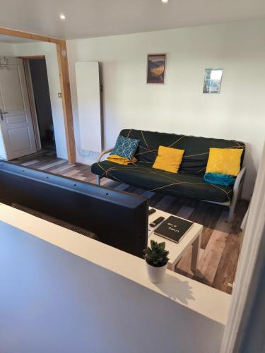 a living room with a couch and a table at à la claire fontaine in Vizille