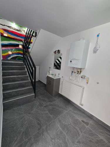 a staircase in a white room with a stair case at Casa MADE in Turda