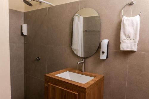 a bathroom with a sink and a mirror at The Living Hub in La Dorada