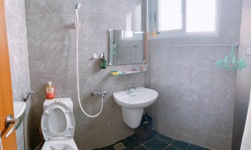 a bathroom with a toilet and a sink at Chongguang Hotel in Tainan
