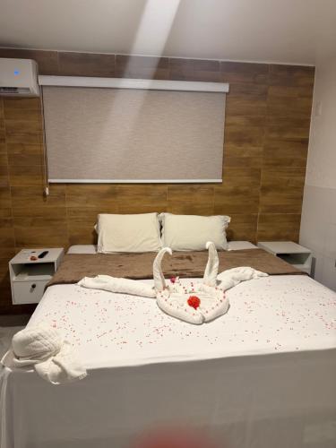 a bed with a cake on top of it at Apartamento com sala e cozinha no morro da saudade in Morro de São Paulo