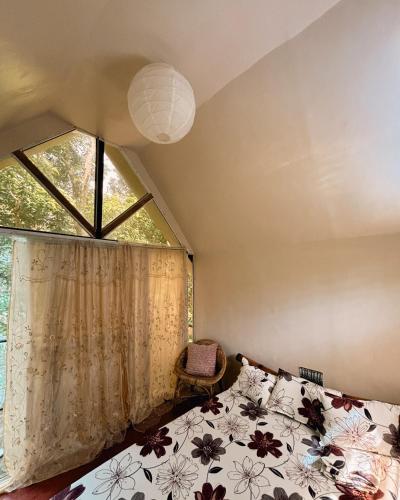 a bedroom with a bed and a window at Cabin Camping at Balay Hilway in Sara