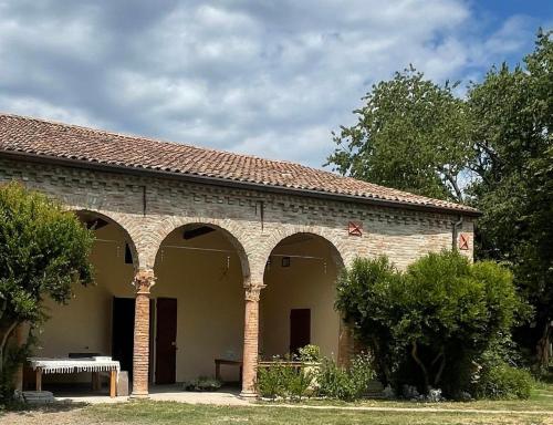 a brick building with arches on the side of it at Podere Misericordia in Ferrara