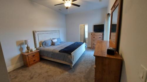 a bedroom with a bed and a dresser and a mirror at Country Resort in Bates City