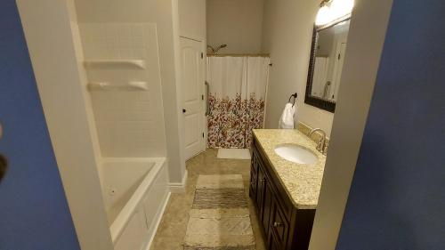 a bathroom with a sink and a shower at Country Resort in Bates City