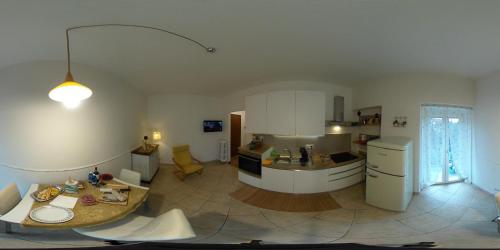 a kitchen and living room with a table in it at Casa Bomba in San Mauro Torinese