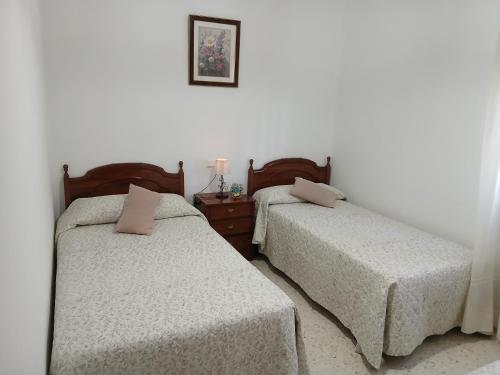 two beds sitting next to each other in a bedroom at Casa La Laguneta in Arcos de la Frontera